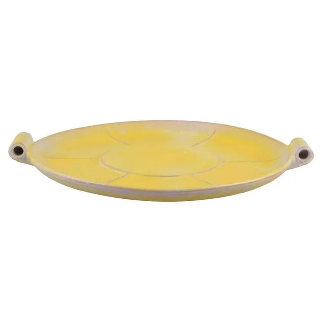 Finnish ceramic dish in Art Deco style. with two handles. Yellow glaze. Hand-painted. Marked ‘Made in Finland’. In...