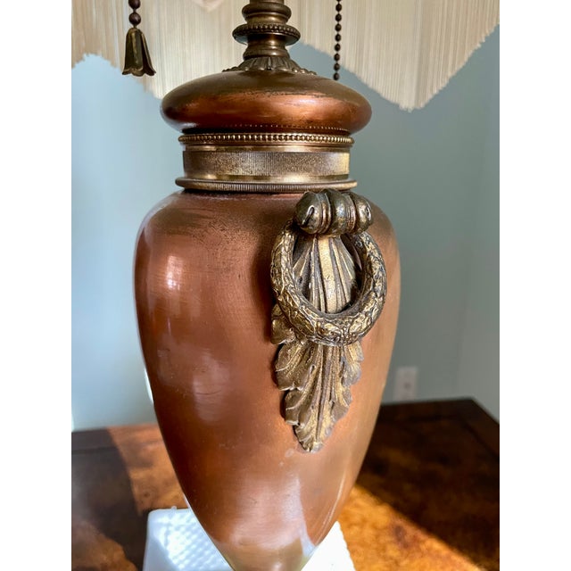 This stunning French bronze table lamp is an exquisite addition to any room. The lamp features a beautiful green marble...