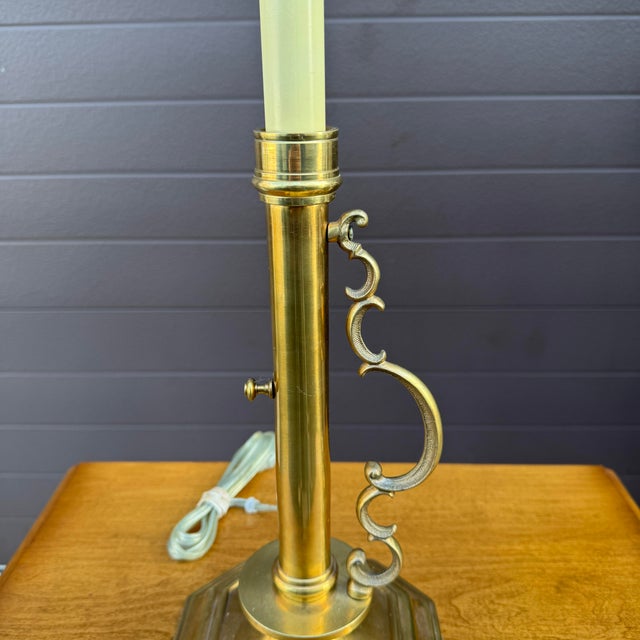 A vintage brass candlestick lamp with a scrolled brass handle by A Homestead Shoppe of LaPaz, Indiana. American made....