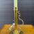 A vintage brass candlestick lamp with a scrolled brass handle by A Homestead Shoppe of LaPaz, Indiana. American made....