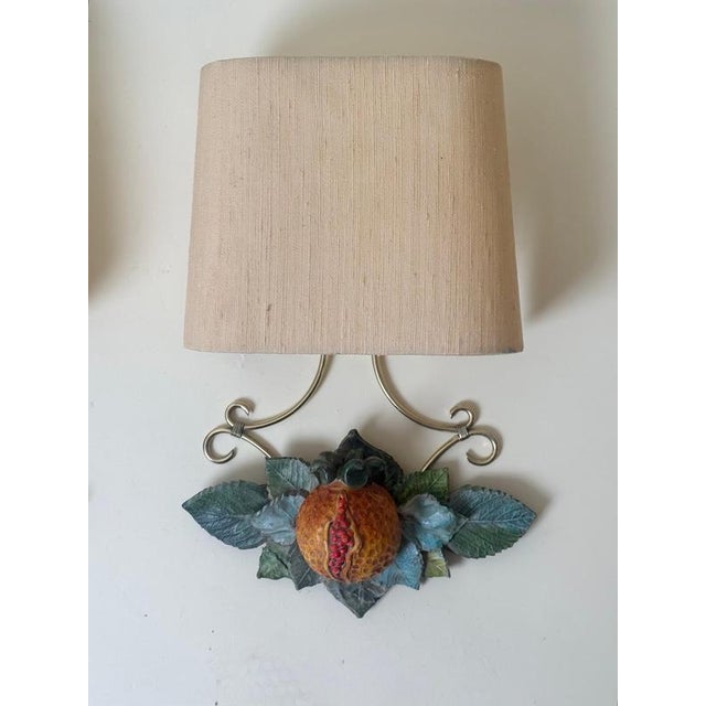 Charming pair of vintage Italian wall sconces featuring beautifully hand-painted terracotta pomegranate decorations,...