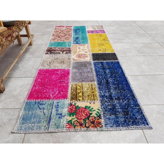 This is a vintage Turkish Oushak rug from the Mid 20th Century. The piece was hand-knotted.