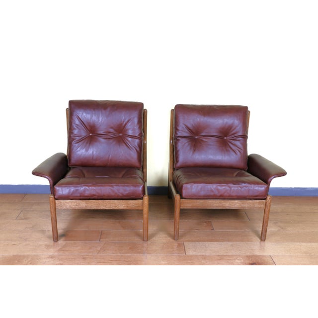 Beautiful Niels Bach lounge chairs completely reupholstered in leather and both have been refinished, They are made of oak...