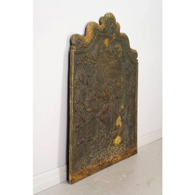 An 18th century French cast iron fireback featuring a highly detailed biblical narrative bas relief. The central scene...