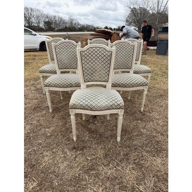 A set of six 19th century Louis XVI-style dining chairs featuring classic square backs, fluted tapered legs, and carved...