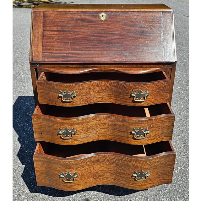 A rare 1940s Johnson Furniture Co Chippendale Mahogany Oxbow Slant Front Desk with 3 drawers with dovetail construction,...