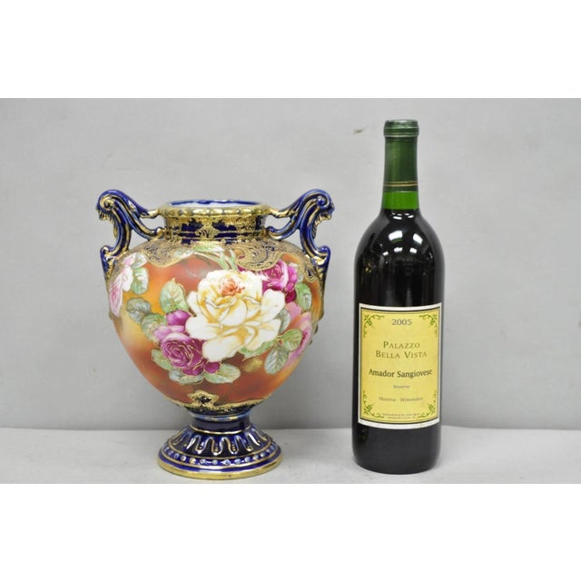 Antique Nippon Hand Painted Floral Design Cobalt Blue Porcelain Bolted Urn Vase with Twin Handles. Circa Early 20th...
