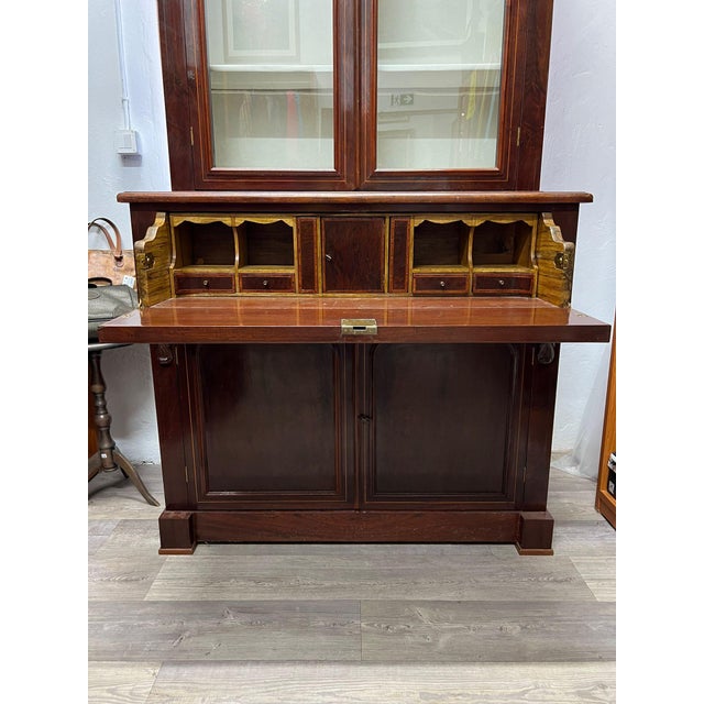 bookcase with desk mahogany secretary early 1900s height: 240 cm width: 120 cm depth: 60 cm This piece is attributed to...