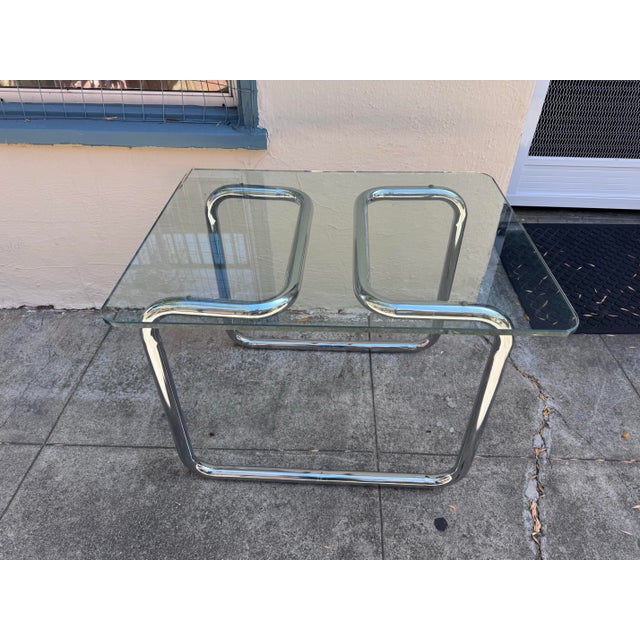 Add a touch of 1970s glamour to your space with this vintage Mid-Century Modern side table, built around a sculptural...