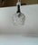 A small German or Scandinavian Diablo shaped pendant light composed of a pressed glass shade in a black metal top upon...