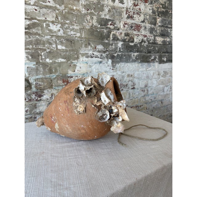 A rare and fascinating piece of maritime history, this antique terracotta octopus trap was authentically used by fishermen...