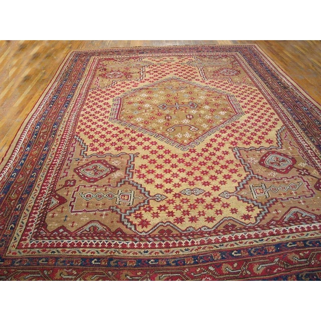 This pale yellow medallion carpet is a direct descendant of classical Ottoman Oushaks with a hexagonal star-filled central...