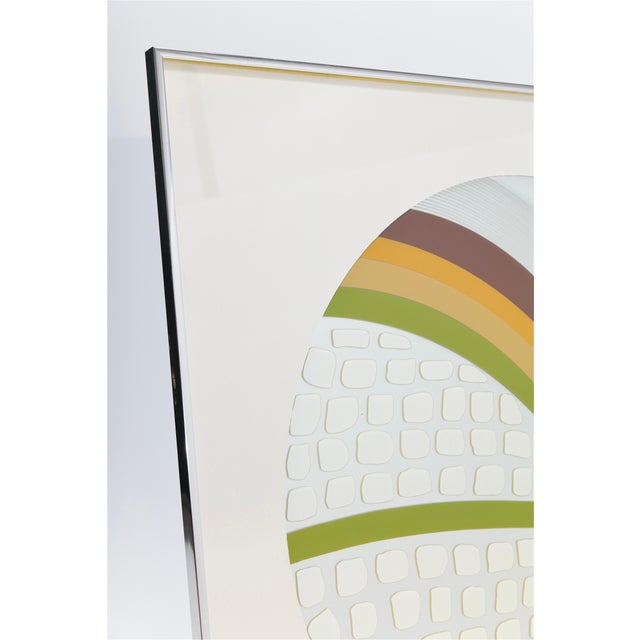 This unique piece of Mid Century wall art features a round mirror set within a sleek chrome metal frame, exuding a modern,...
