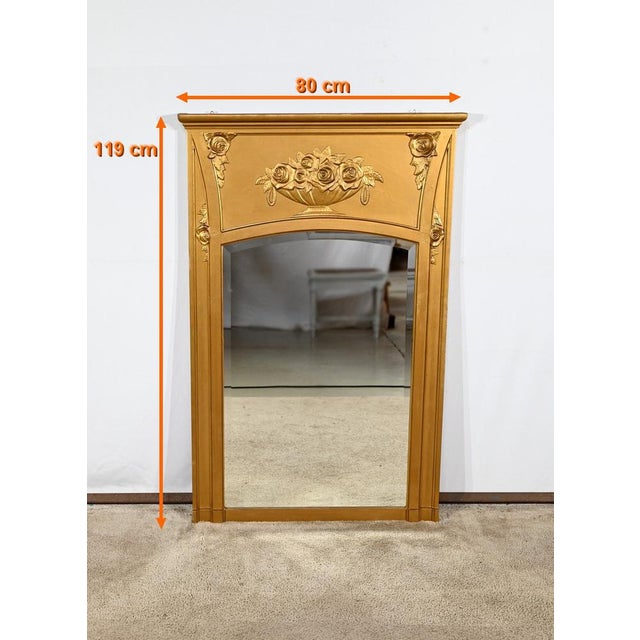 This rectangular mirror, made of wood and gilded staff, is dark with original beveled glass. The pediment has a cut...