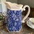 This Antique English Calico Blue & White Floral Stoneware Pitcher is a charming collectible piece from the United Kingdom....