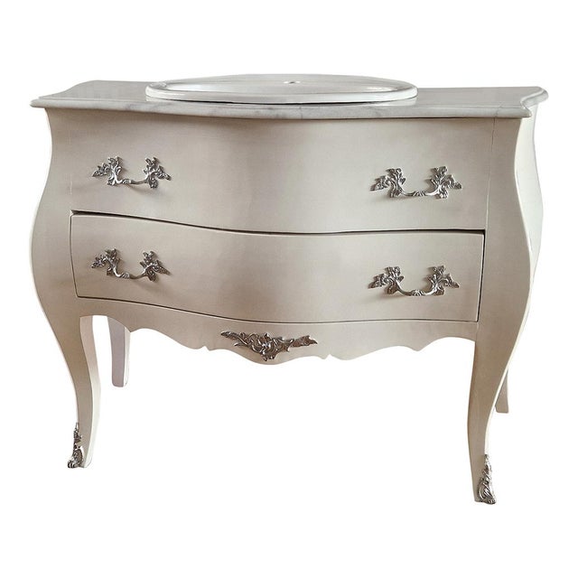 Baroque bathroom cabinet with a wavy front and sides, equipped with a drawer, made of ivory lacquered wood and enriched...