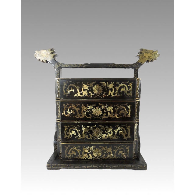 Eye catching old Chinese black lacquer three tier wedding box or chest with an unusual horizontal double dragon headed...