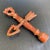 Vintage metal lampshade finial in the form of a columnar post with a cross arrow, including some chippy dark burgundy red...