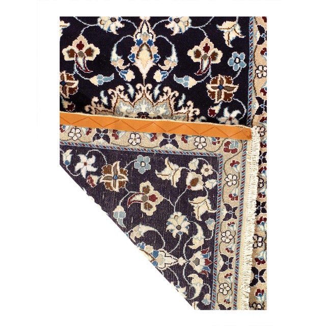 Persian Nain rugs are renowned for their detail and fine use of outlining along the central motifs. Breaking from the...