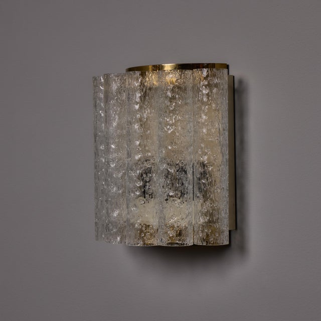 Pair of 1970s Doria Leuchten Brass and Ice Glass Wall Lamps Executed in thick ice glass, this curved wall mount lamp...