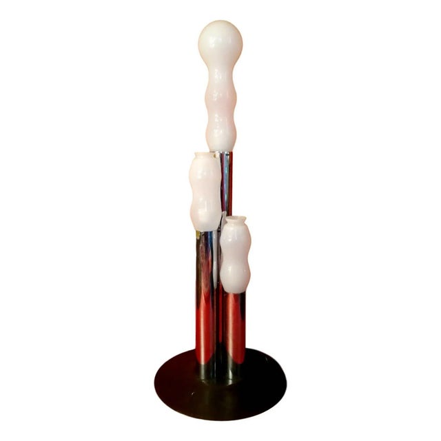 Original floor lamp from the 1970s, made of a metal structure with a wide base and three mouth-blown opaline glass...