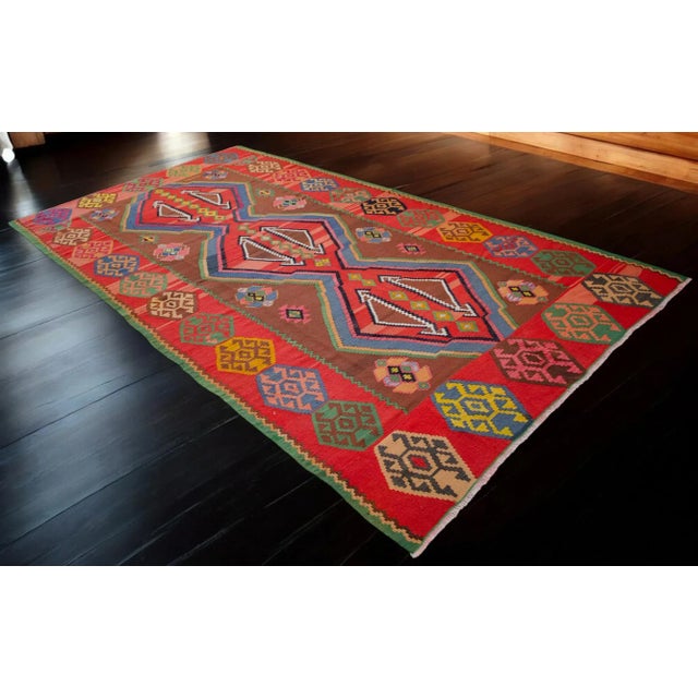 Add a pop of vintage charm to your living room with this handmade Turkish kilim rug! Measuring approximately 7x13 ft, this...