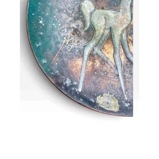 Mid-century Dutch enamel-on-copper decorative dish featuring a stylized fawn set against a richly mottled teal, brown and...