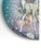 Mid-century Dutch enamel-on-copper decorative dish featuring a stylized fawn set against a richly mottled teal, brown and...