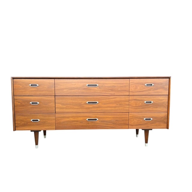 This beautifully restored 1960s nine-drawer dresser embodies classic Mid-Century Modern design with clean lines and...