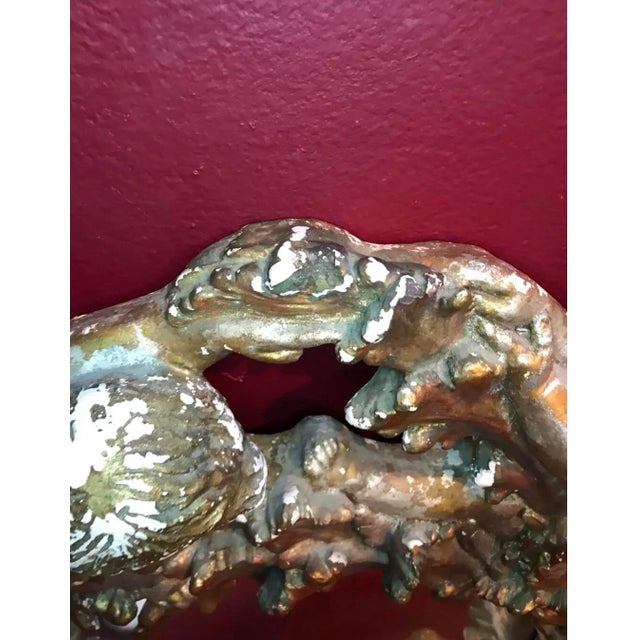 19 century mirror with this dress gilt frame with cherubs and acanthus leaves 9 inch wide circular frame made of plaster...