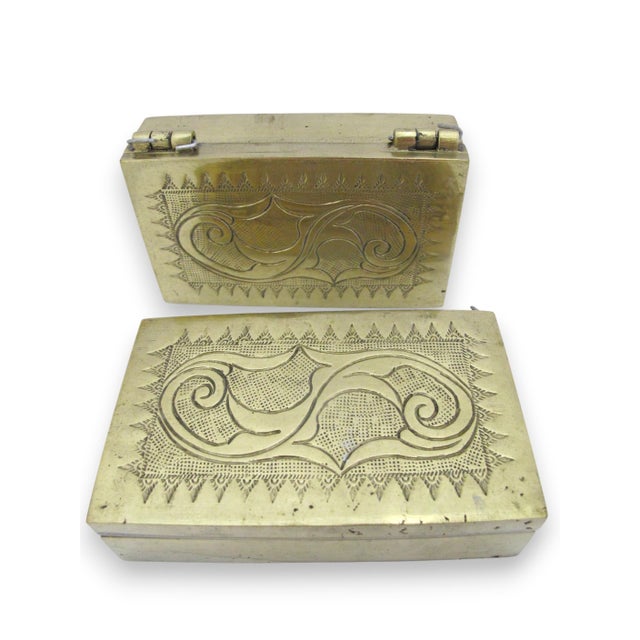 Pair of old brass Betel Nut boxes from Philippines or Indonesia. Heavy brass with engraved scrollwork. Each box has a...