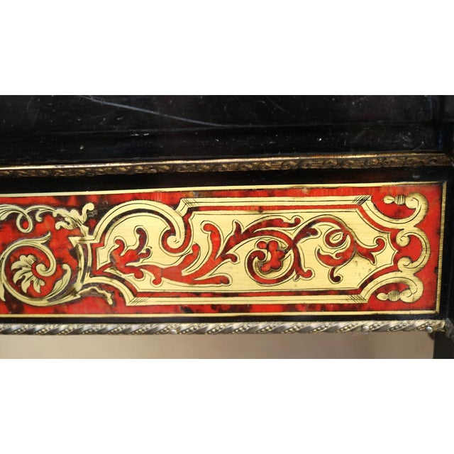 Antique inlaid sideboard in Boulle Napoleon III style, late 19th century. Straight silhouettes, with a front door inside a...