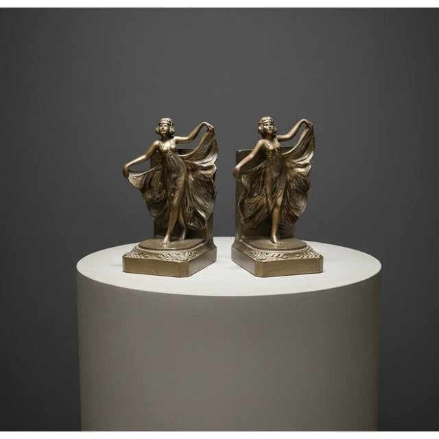 Celebrate the glamour of the Jazz Age with this antique pair of Art Deco spelter bookends featuring graceful dancing...