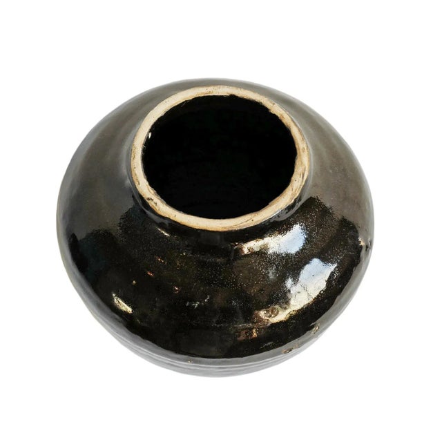 Vintage black glazed ceramic jar. Each is slightly unique in handmade and vintage qualities. Opening at top is 3.5"...