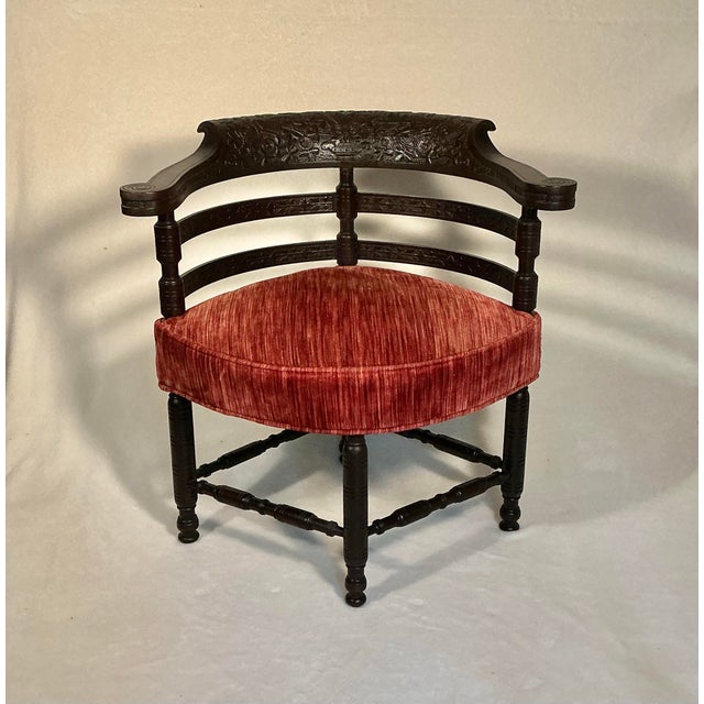 Antique robust corner, or roundabout accent chair made of rosewood and rosewood veneer, American made 1870-1880. Features...