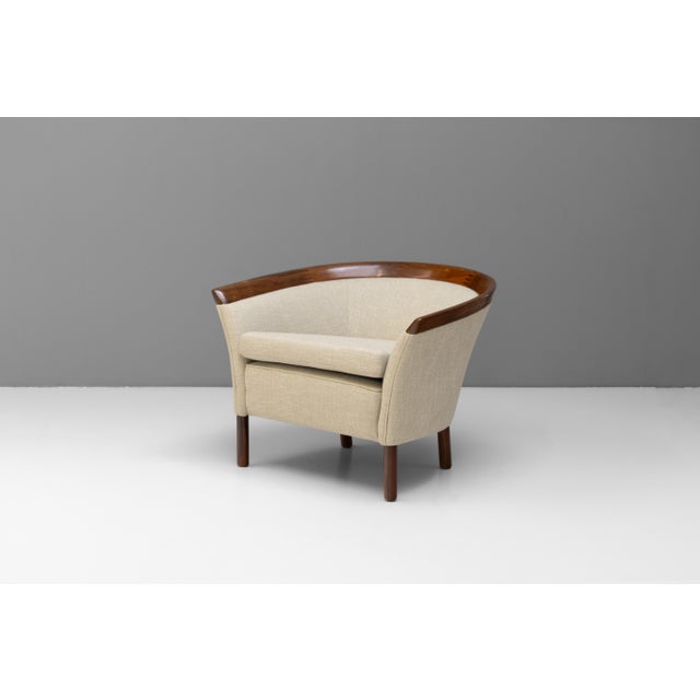 Mid-Century Danish armchair with solid teak legs and back. Newly coved in beige fabric. Denmark circa 1960.