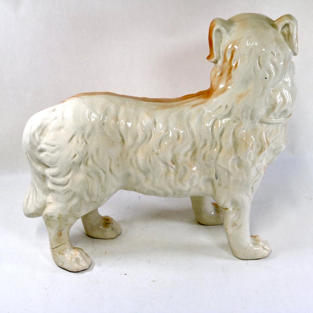A striking and rare matched pair of large, 19th-century Victorian Staffordshire earthenware mantel dogs. Unlike the...