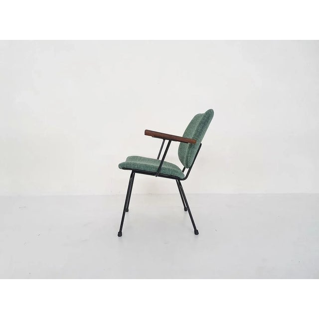 Black metal frame with teak armrests and new green upholstery.