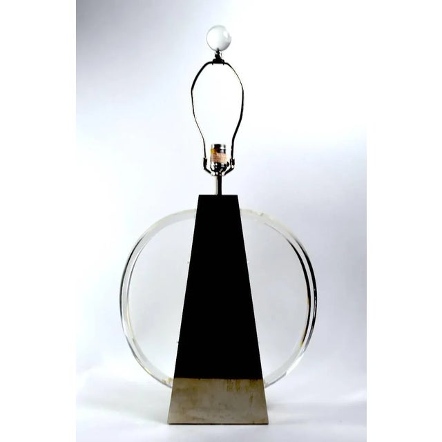 Slick modernist pair of chrome and Lucite table lamps by Chapman. Both are in excellent, original, working condition....