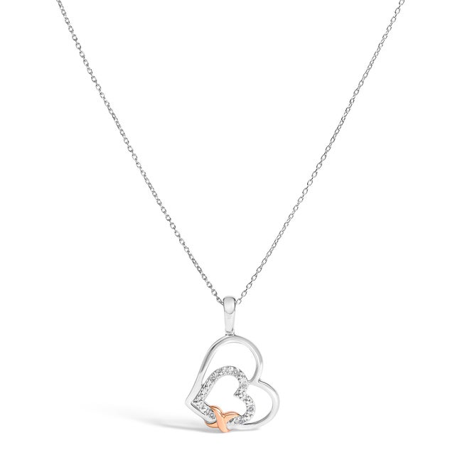 Adorn your neckline with the delicate allure of this double heart pendant, masterfully crafted from .925 sterling silver...