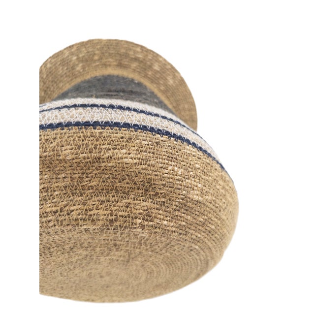 A beautifully sculpted handwoven basket crafted in India, where traditional techniques meet a bold, architectural...
