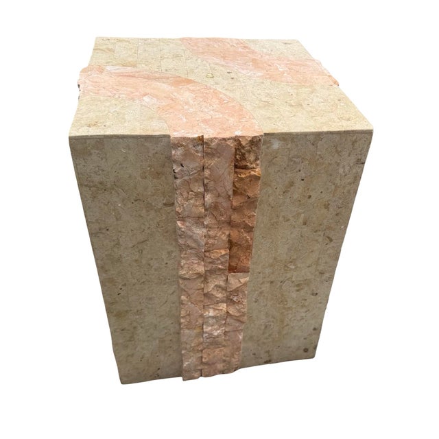 The substantial architectural base is clad in warm beige natural stone accented with dramatic vertical bands of rough-cut...