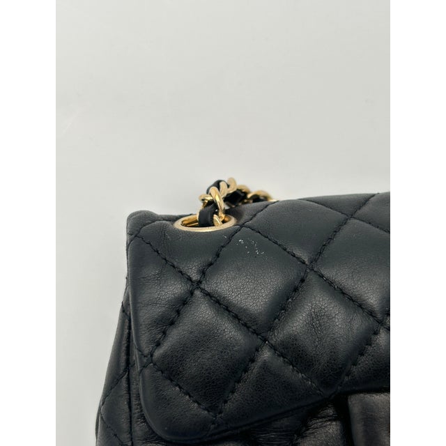 Extra Mini Black Chanel Flap Bag. Coveted icon in miniature form, this vintage Chanel Mini Classic Flap Bag embodies...