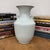 "About This Piece About This Piece Pure and serene, this vase gleams in a soft white glaze that enhances its elegant...