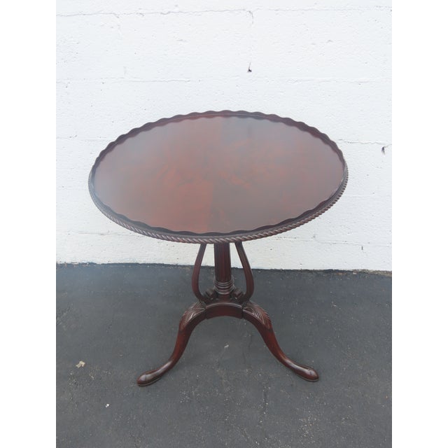 This Side Table is made of wood, mahogany, flame mahogany, and veneer. It was made by Weiman Furniture, and it is labeled....