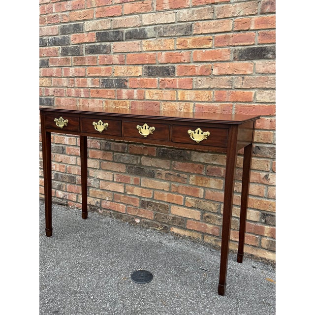 Nothing is quite as English as a mahogany side table with George III brass hardware pulls! The 4 drawers still glide...
