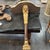 A fabulous decorative wall bracket with faux marble top and single wood leg with a hand carved profile of a lion at top...