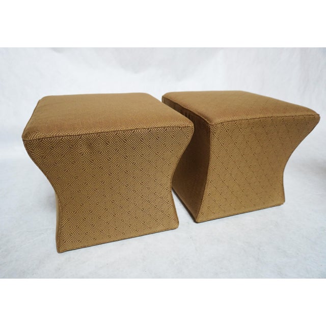 Funky pair of ottomans custom upholstered by Ross. These ottomans are done in a classic tan and gold diamond-pattern...