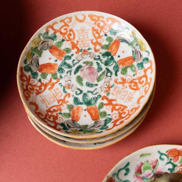 This petite porcelain dish from the mid-19th century is hand-painted with red & green overglaze enamels in the famille...