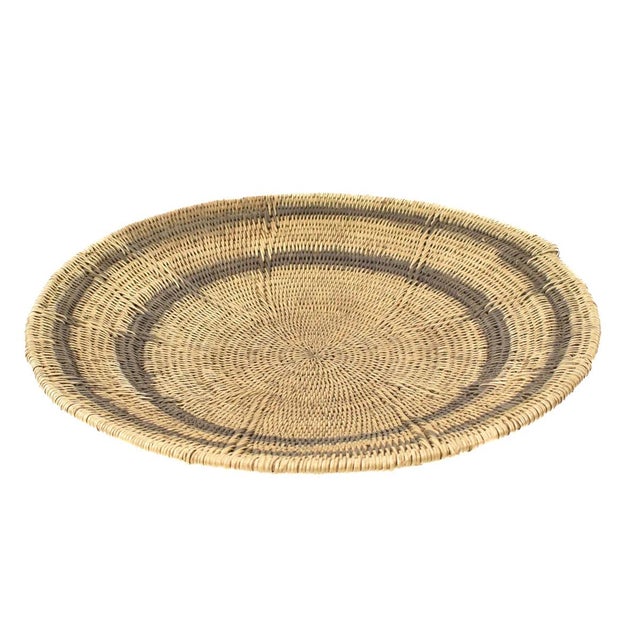 Handwoven Makenge flat wedding basket handmade by the Mbundu women within Zambia. These baskets are traditionally made...
